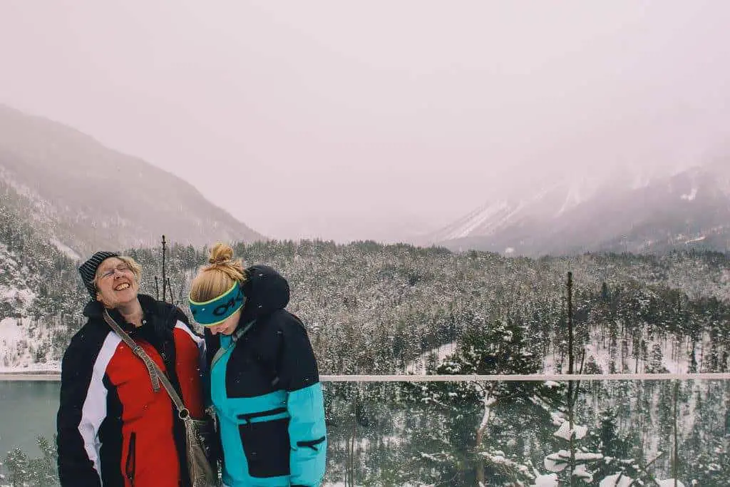 Me and my mum laughing about something while traveling together in winter in the Alps