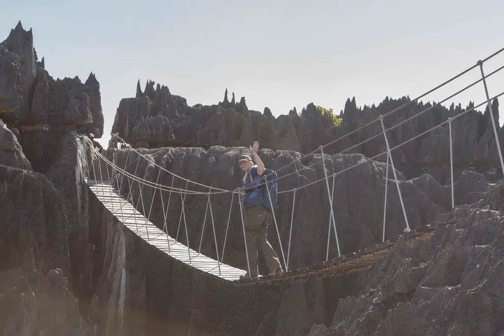 crossing a via ferrata suspension bridge in Madagascar