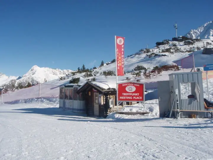 ski school meeting point in mayrhofen with signs to welcome new students