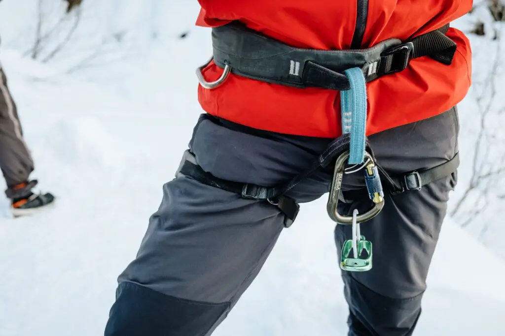 Close up of a climbing harness and belay device for ice climbing