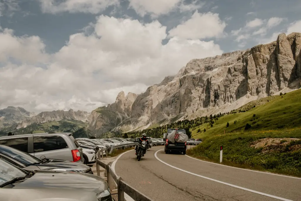 A photo showing the busy Sella Pass in the Dolomites and lots of parked cars